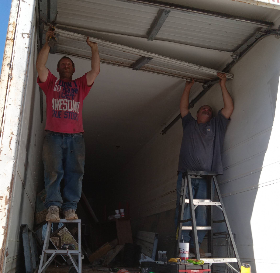 McGriff Repair technicians working on a commercial overhead door